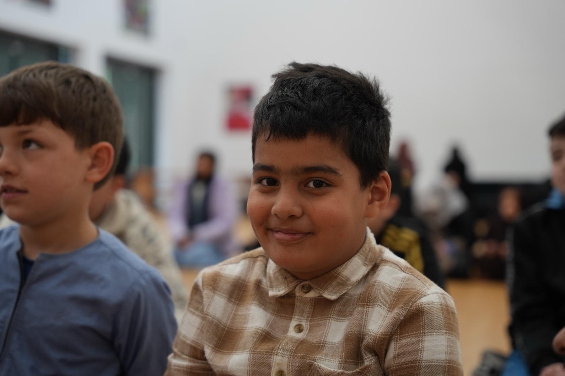 A smiling student during morning assembly