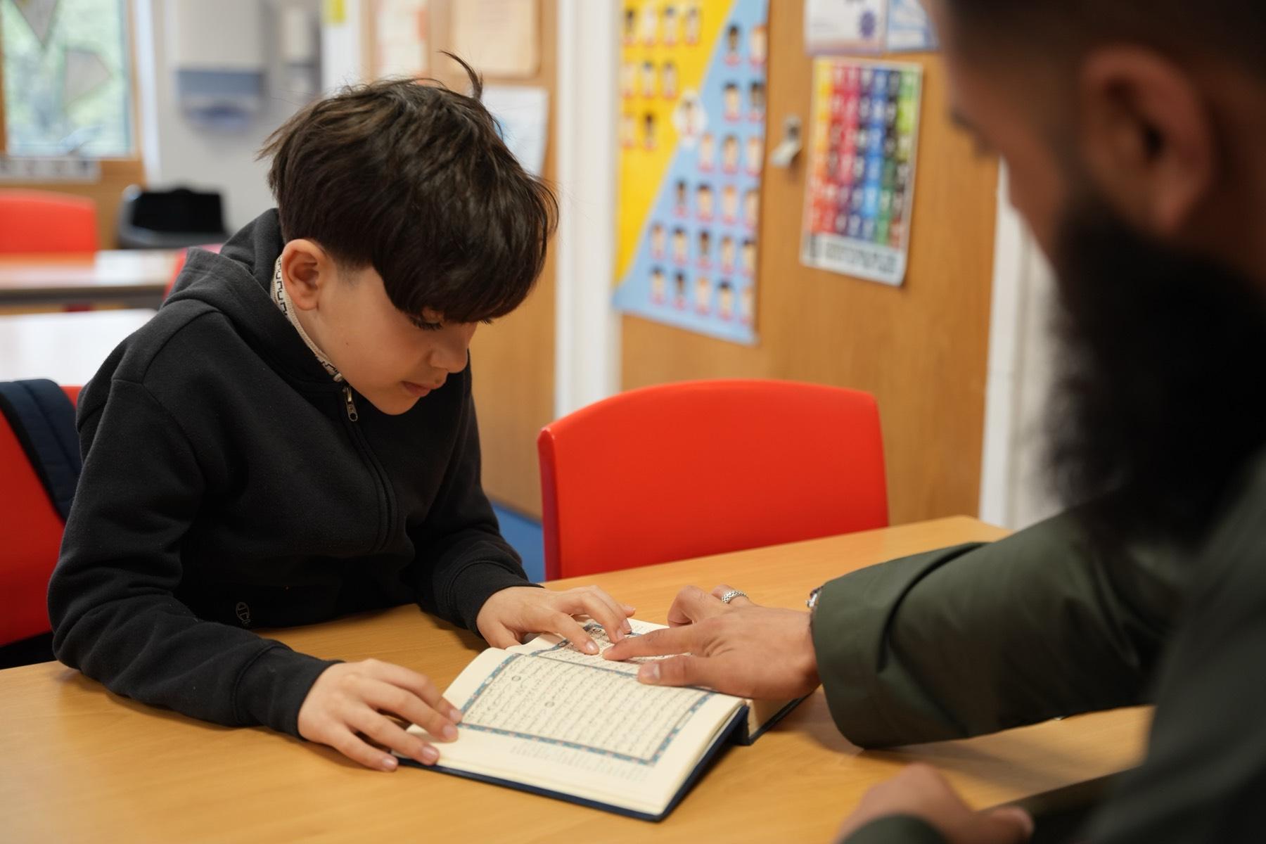 A teacher guiding a student one-to-one